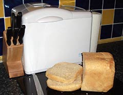 A loaf of bread and a bread maker