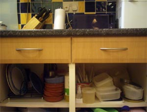 cluttered kitchen cupboard
